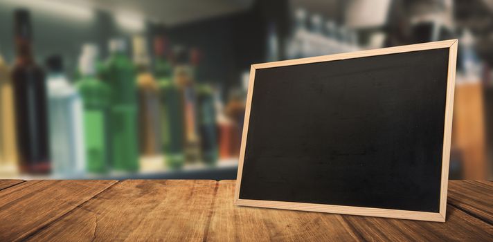 Bottles arranged on a shelf against blackboard with copy space