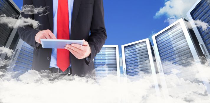 Businessman scrolling on his digital tablet against scenic view of blue sky