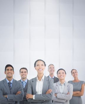 Business people looking up in office against abstract background