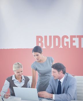 Business people using laptop against budget
