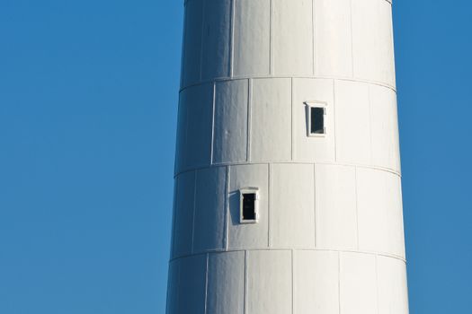 A close-up of the tall white lighthouse tower at slangkop, Cape Town, South Africa