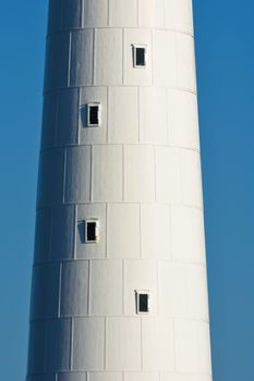 The tall white lighthouse tower at slangkop round structure close-up, Cape Town, South Africa