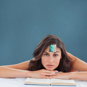 Frowning student head on her books against blue background