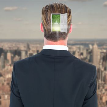 Rear view of elegant businessman in suit posing against new york