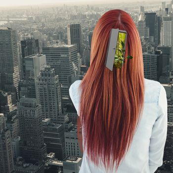 Rear view of hipster woman looking post-it against view of cityscape