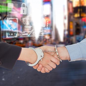 Business people in handcuffs shaking hands against blurry new york street