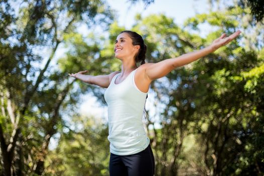 Woman smiling and doing yoga on the wood