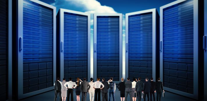 Rear view of multiethnic business people standing side by side against composite image of server room