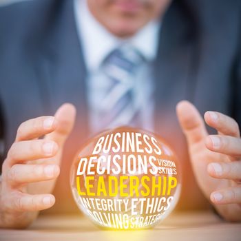 The word leadership  against businessman forecasting a crystal ball 