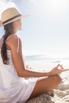  Rear view of woman performing yoga on the beach