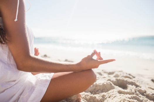  Rear view of woman performing yoga on the beach