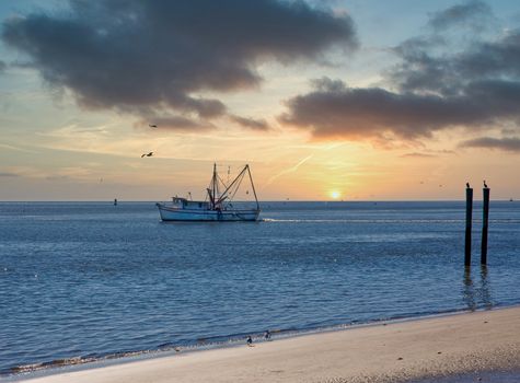 A shrimp boat working the calm blue water off the coast