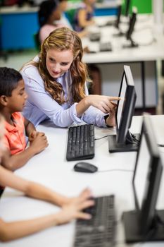 Teacher giving lesson to her students with technology at school