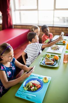 Children using technology during lunch at school