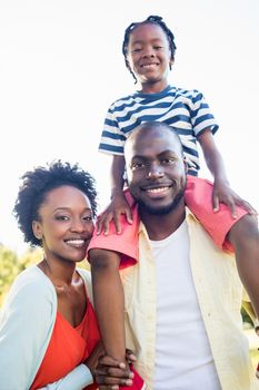 Happy family posing together at park