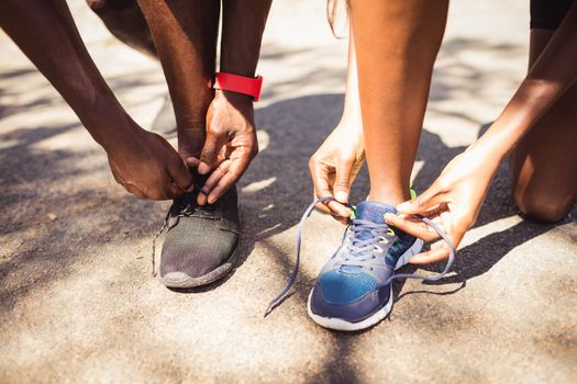 Focus on family doing laces at park