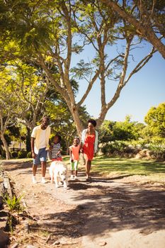 Happy family walking together at park 