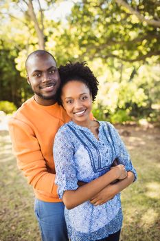 Happy couple posing together at park