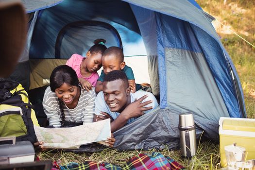 Happy family lying together at park