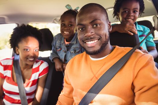 Happy family posing together in a car