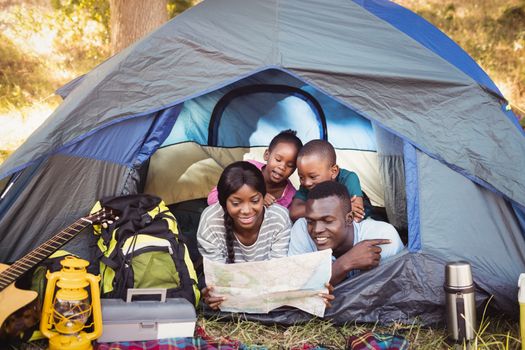 Happy family lying together at park