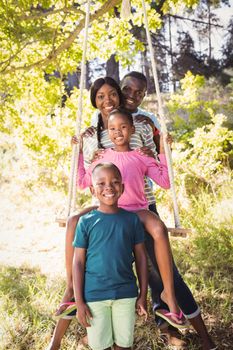 Happy family posing together at park