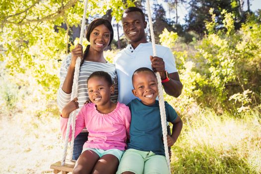 Happy family posing together at park