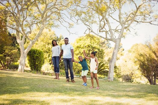 Happy family walking together at park 