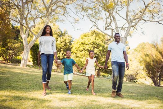 Happy family walking together at park 