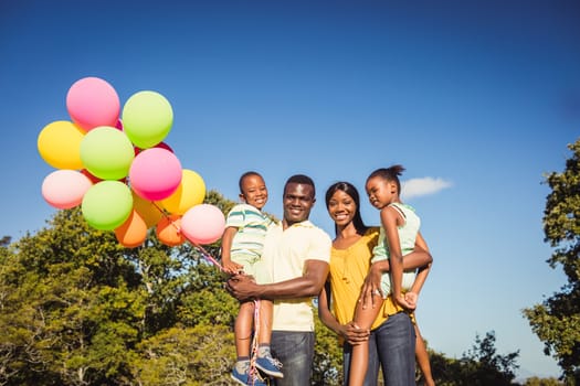 Happy family posing together at park