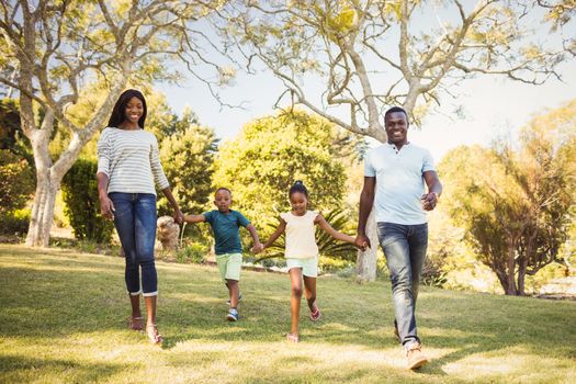 Happy family walking together at park 