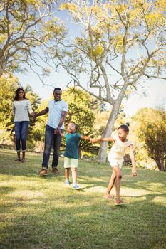 Happy family walking together at park 