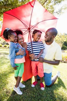 Happy family posing together at park