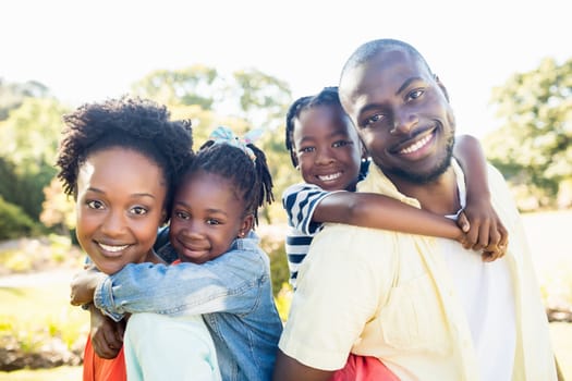 Happy family posing together at park