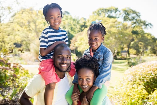 Happy family posing together at park