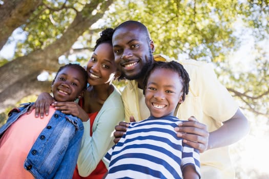 Happy family posing together at park