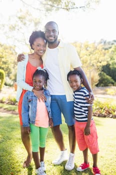 Happy family posing together at park