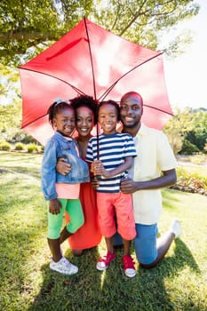 Happy family posing together at park