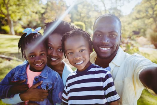 Happy family posing together at park