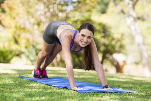 Portrait of young woman doing yoga in park