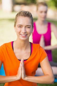 Close-up of beautiful woman practicing yoga in park