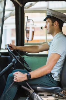 Confident bus driver driving a bus