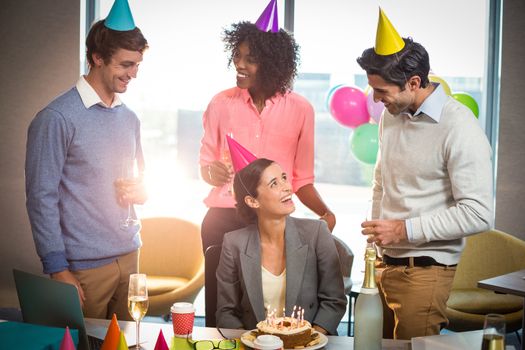 Business people celebrating birthday in office