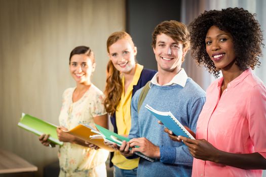 Business people holding files in office