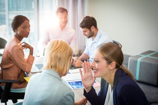 Business people gossiping during meeting in the office