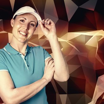 Sportswoman posing on black background against angular design