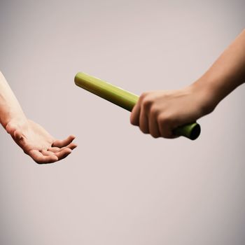 Athlete passing a baton to the partner