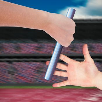 Close up of sportsman is holding a baton for a relay race 