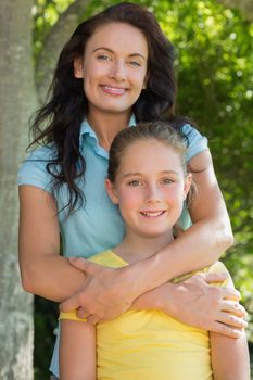 Portrait of mother and daughter standing in park