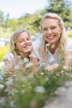 Portrait of mother and daughter smiling in park
